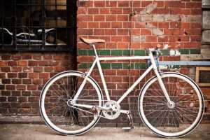 city bicycle on red wall vintage style P8TDVDN 300x200 -